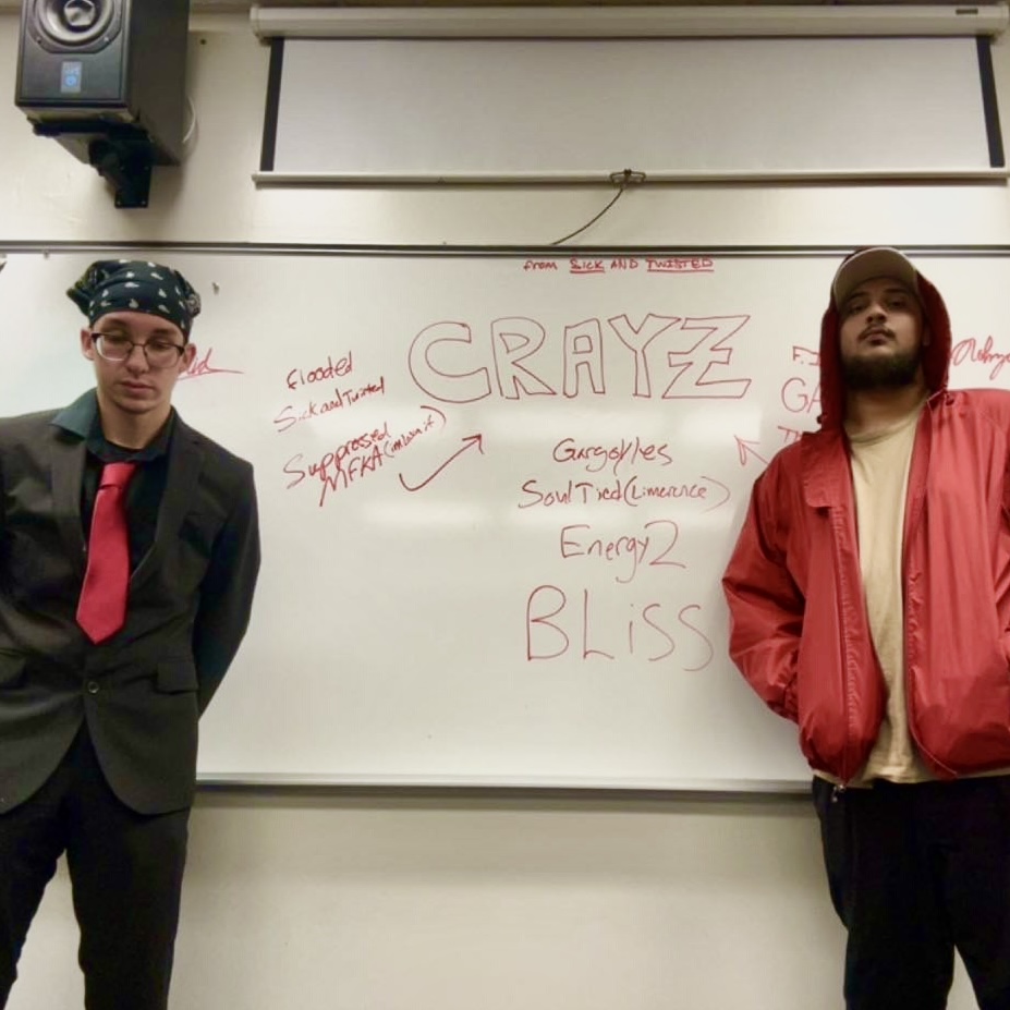 Nohzat and another person photographed near a whiteboard
