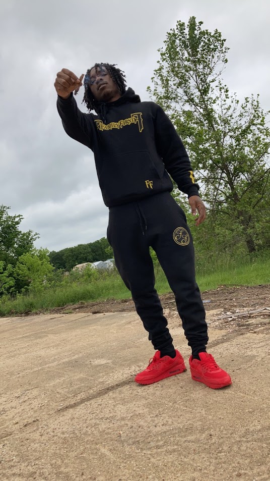 Keylo Nsane standing outdoors in a black Family First sweatsuit