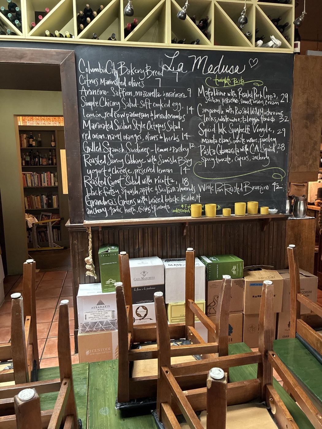 Chalkboard menu above the dining room at La Medusa Sicilia.