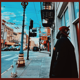 Artist-submitted cover image for Brodiee's self-titled track, showing a street scene with palm trees and buildings.