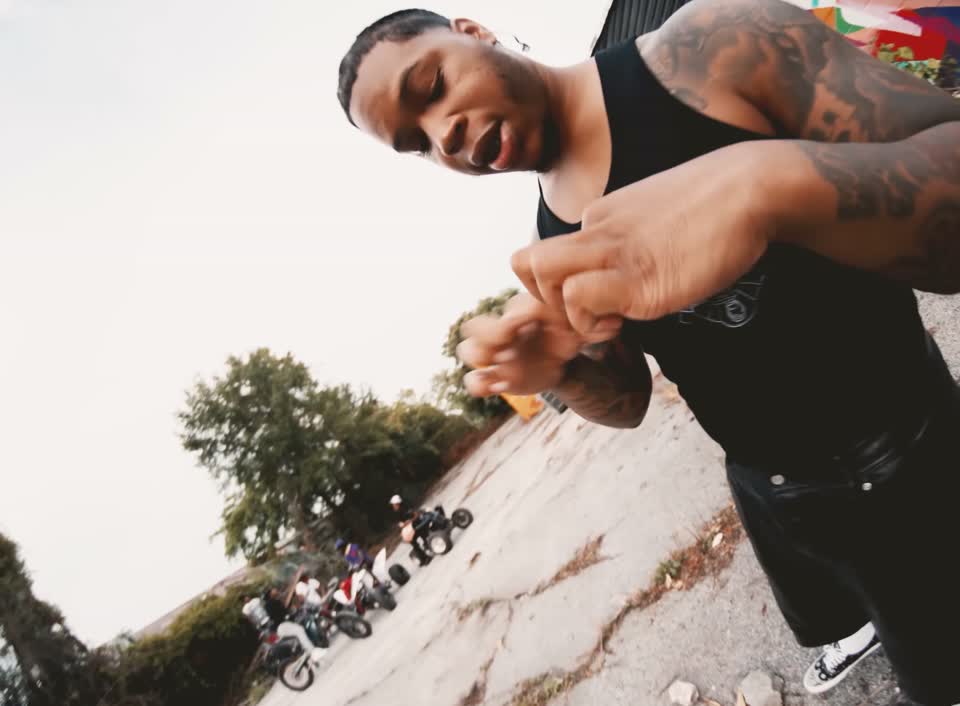 Fox BD close to the camera in a black shirt during the official performance video.